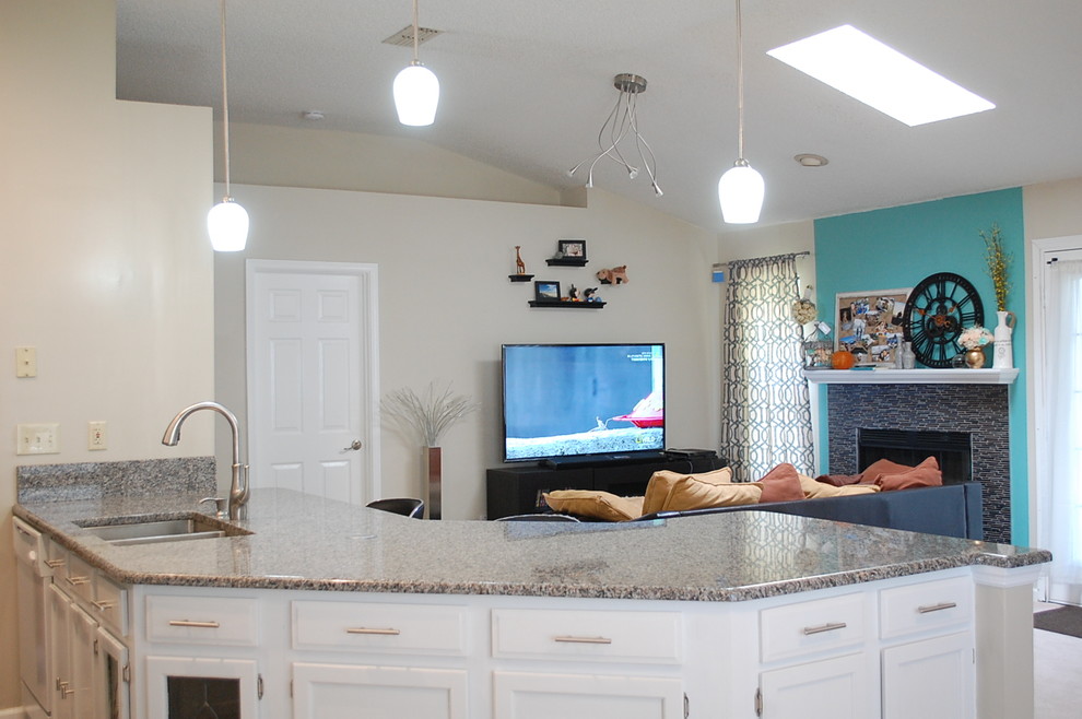 Cette photo montre une cuisine chic en U avec un placard à porte shaker, des portes de placard blanches et un plan de travail en granite.