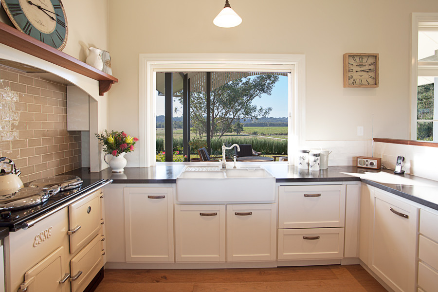 Inspiration for a medium sized farmhouse u-shaped kitchen in Central Coast with shaker cabinets, beige cabinets, engineered stone countertops and metro tiled splashback.