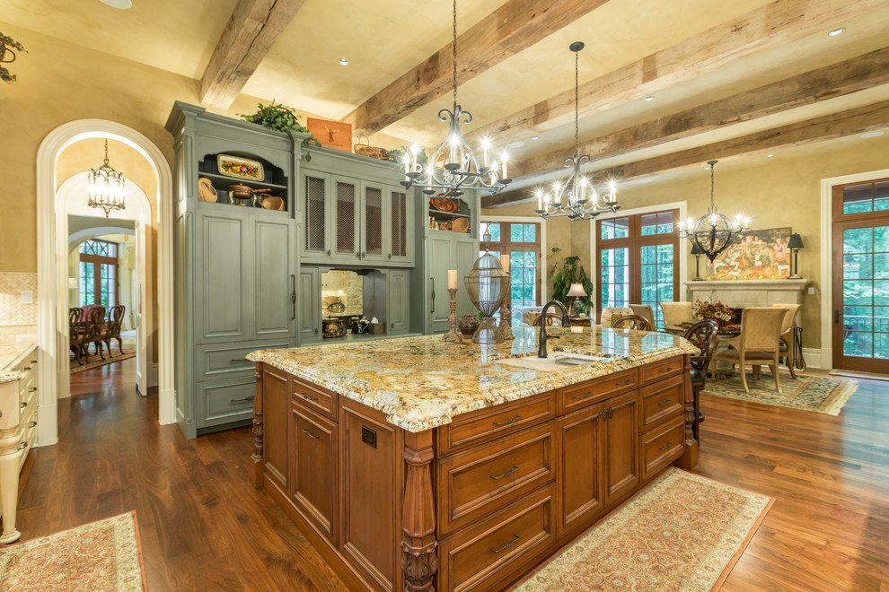 Eat-in kitchen - huge traditional u-shaped medium tone wood floor eat-in kitchen idea in DC Metro with raised-panel cabinets, granite countertops, stainless steel appliances and an island