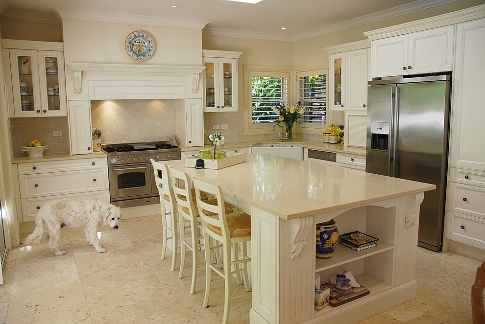 Inspiration for a large timeless l-shaped travertine floor eat-in kitchen remodel in Sydney with a farmhouse sink, shaker cabinets, white cabinets, quartz countertops, beige backsplash, ceramic backsplash, stainless steel appliances and an island