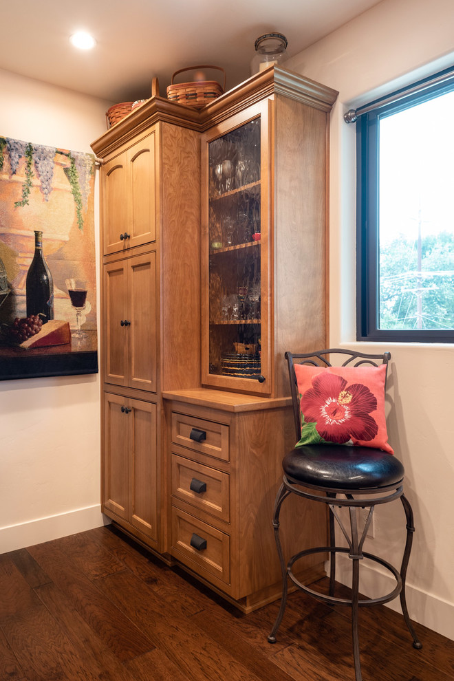 Large tuscan l-shaped dark wood floor and brown floor eat-in kitchen photo in San Luis Obispo with a drop-in sink, recessed-panel cabinets, medium tone wood cabinets, quartz countertops, beige backsplash, stone tile backsplash, stainless steel appliances, an island and beige countertops