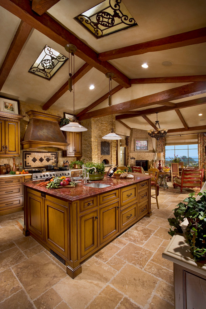 Large tuscan single-wall eat-in kitchen photo in Orange County with a single-bowl sink, recessed-panel cabinets, medium tone wood cabinets, beige backsplash, stainless steel appliances and an island