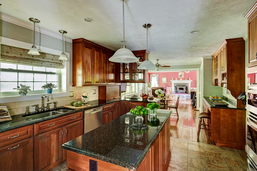 Mid-sized elegant porcelain tile and brown floor eat-in kitchen photo in Other with a double-bowl sink, raised-panel cabinets, light wood cabinets, granite countertops, beige backsplash, ceramic backsplash, stainless steel appliances and an island