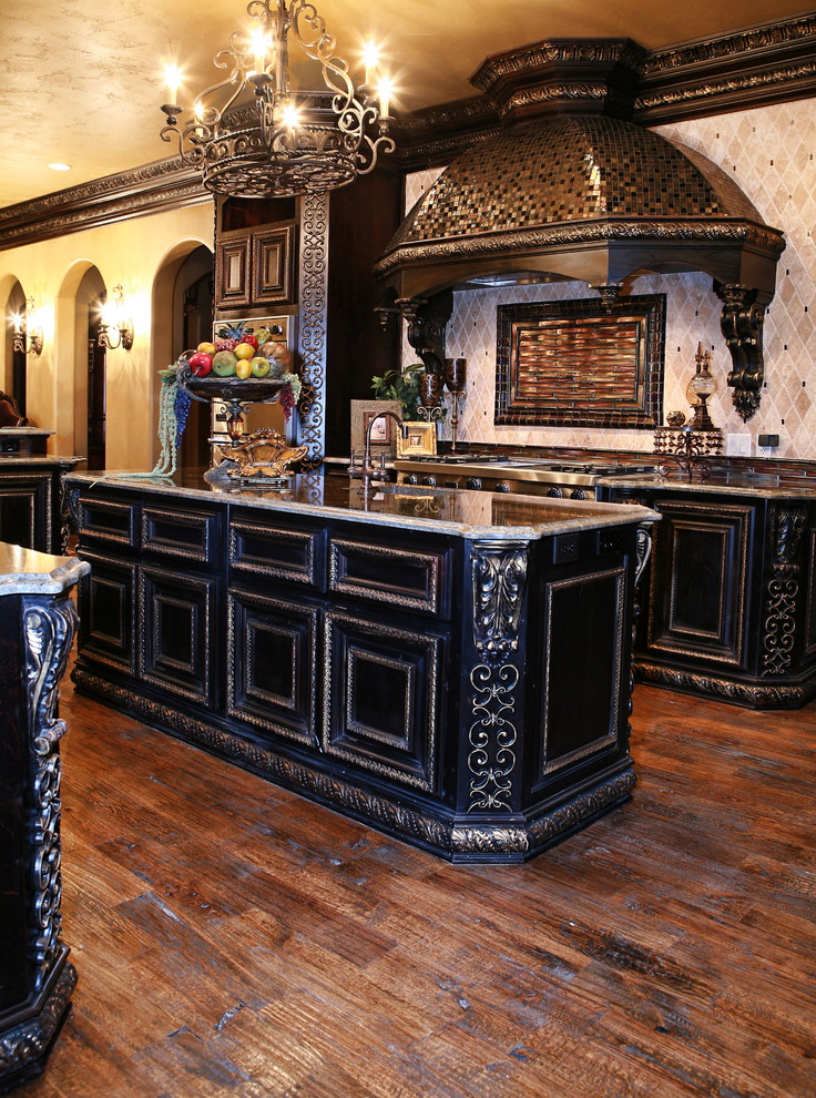 This is an example of an expansive traditional u-shaped kitchen/diner in Dallas with a submerged sink, raised-panel cabinets, dark wood cabinets, granite worktops, stainless steel appliances, medium hardwood flooring, an island, brown floors and brown worktops.