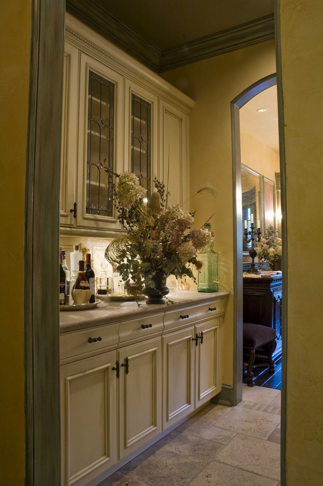 Cette photo montre une cuisine méditerranéenne avec un placard avec porte à panneau encastré et des portes de placard beiges.
