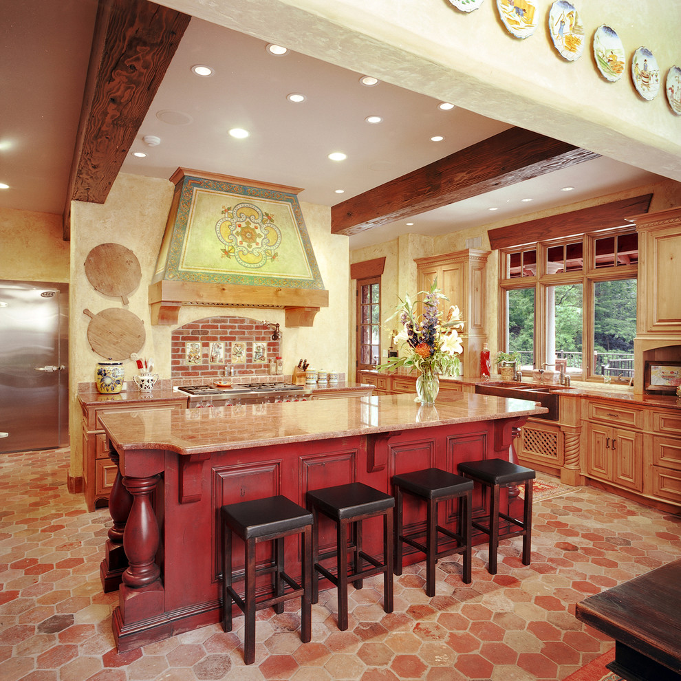 Large tuscan l-shaped red floor kitchen photo in Kansas City with a farmhouse sink, granite countertops, brick backsplash, stainless steel appliances, an island, raised-panel cabinets, red cabinets and red backsplash