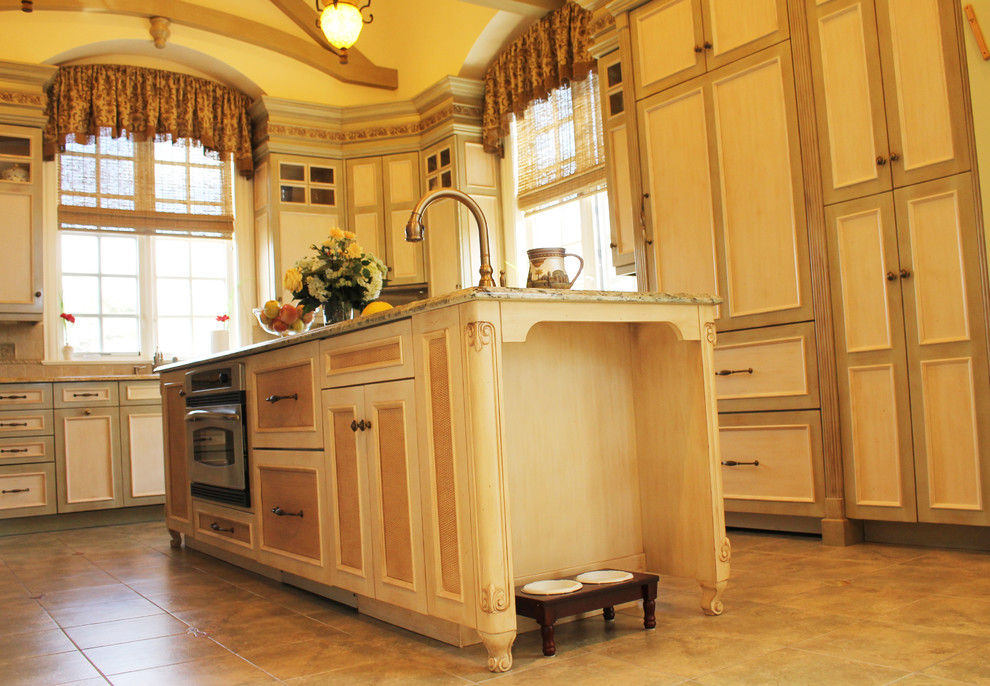 Eat-in kitchen - large mediterranean u-shaped ceramic tile eat-in kitchen idea in New York with raised-panel cabinets, light wood cabinets, marble countertops, multicolored backsplash, mosaic tile backsplash, colored appliances, an island and a single-bowl sink