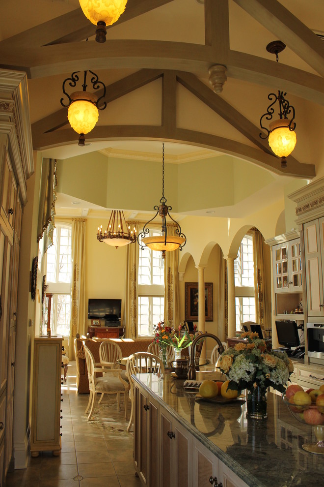 Example of a large tuscan u-shaped ceramic tile eat-in kitchen design in New York with raised-panel cabinets, light wood cabinets, marble countertops, multicolored backsplash, mosaic tile backsplash, colored appliances, an island and a single-bowl sink