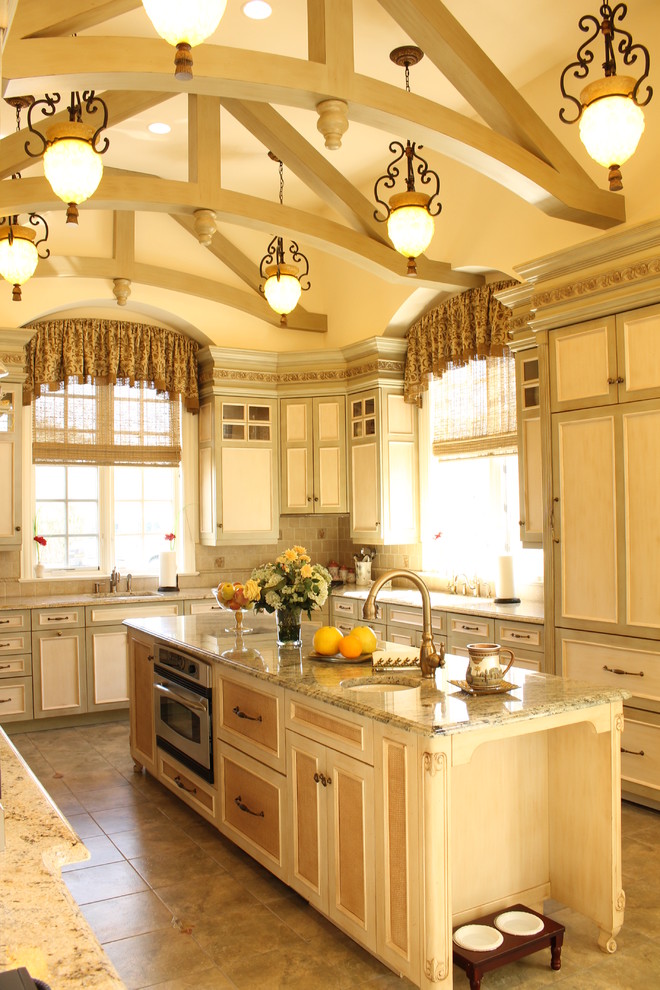 Inspiration for a large mediterranean u-shaped porcelain tile eat-in kitchen remodel in New York with raised-panel cabinets, light wood cabinets, marble countertops, multicolored backsplash, mosaic tile backsplash, colored appliances, an island and a single-bowl sink