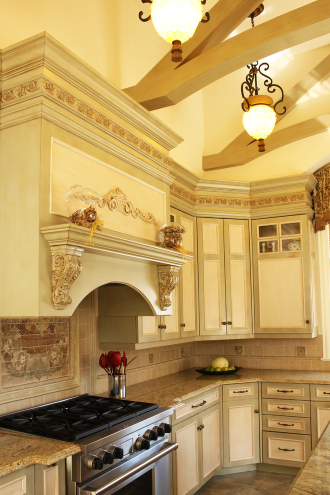Inspiration for a large mediterranean u-shaped ceramic tile eat-in kitchen remodel in New York with raised-panel cabinets, light wood cabinets, marble countertops, multicolored backsplash, mosaic tile backsplash, colored appliances, an island and a single-bowl sink