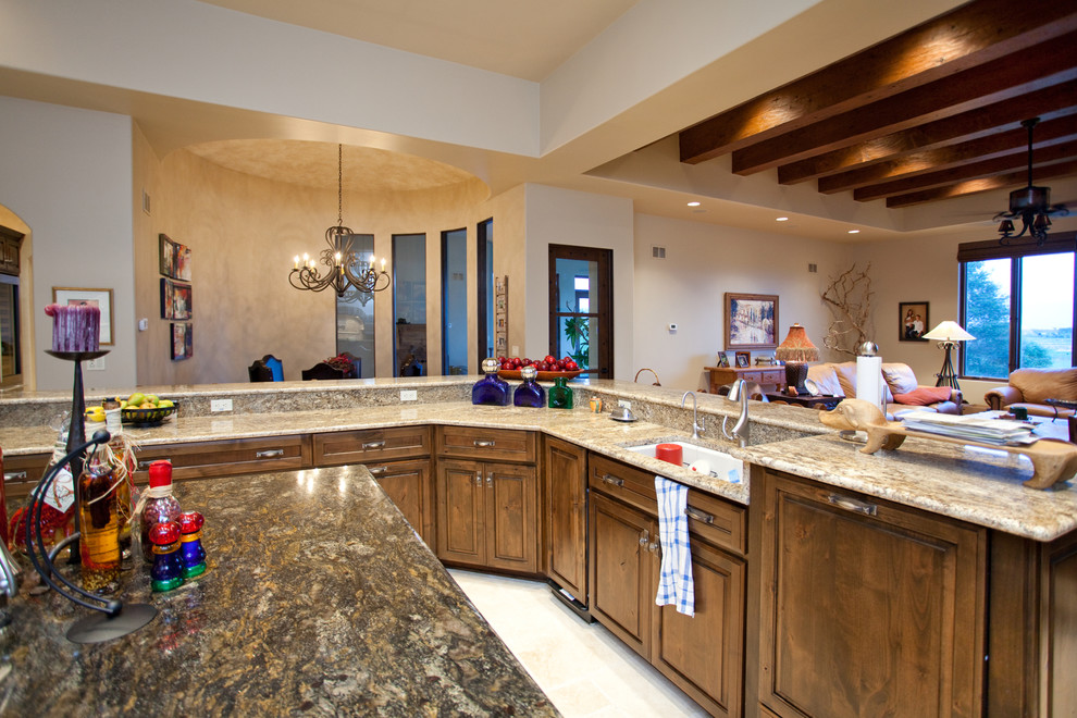Large elegant l-shaped limestone floor eat-in kitchen photo in Chicago with a single-bowl sink, raised-panel cabinets, dark wood cabinets, granite countertops, beige backsplash, paneled appliances and an island
