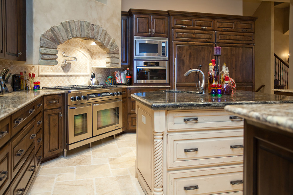 Example of a large classic l-shaped limestone floor eat-in kitchen design in Chicago with a single-bowl sink, raised-panel cabinets, dark wood cabinets, granite countertops, beige backsplash, paneled appliances and an island