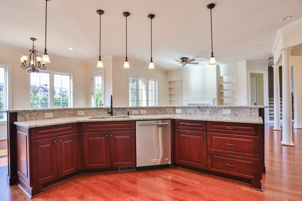 Example of a large tuscan l-shaped medium tone wood floor open concept kitchen design in Raleigh with a double-bowl sink, raised-panel cabinets, dark wood cabinets, granite countertops, gray backsplash, stone tile backsplash, stainless steel appliances and an island