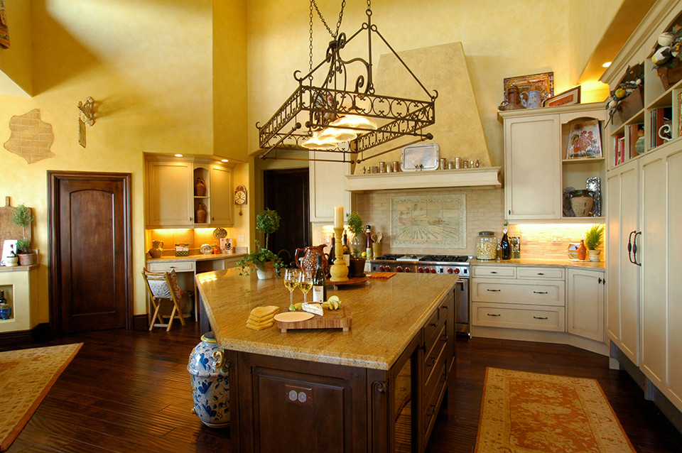 This is an example of a large traditional u-shaped kitchen in San Francisco with raised-panel cabinets, distressed cabinets, granite worktops, beige splashback, mosaic tiled splashback, stainless steel appliances, dark hardwood flooring and an island.