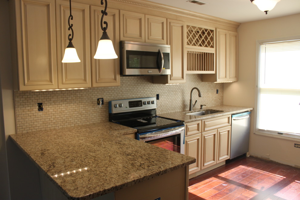 Eat-in kitchen - small traditional galley eat-in kitchen idea in Philadelphia with an undermount sink, raised-panel cabinets, beige cabinets, granite countertops, beige backsplash, stone tile backsplash and a peninsula