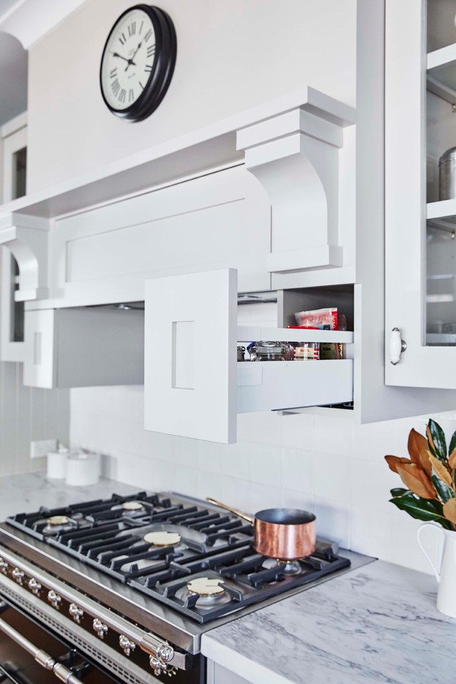 シドニーにある中くらいなトラディショナルスタイルのおしゃれなキッチン (エプロンフロントシンク、シェーカースタイル扉のキャビネット、グレーのキャビネット、白いキッチンパネル、シルバーの調理設備、無垢フローリング) の写真