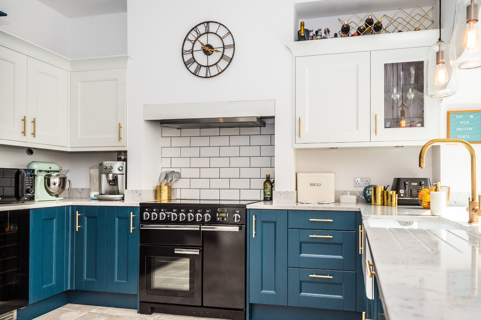 Mid-sized trendy kitchen photo in London with white backsplash, ceramic backsplash and white countertops