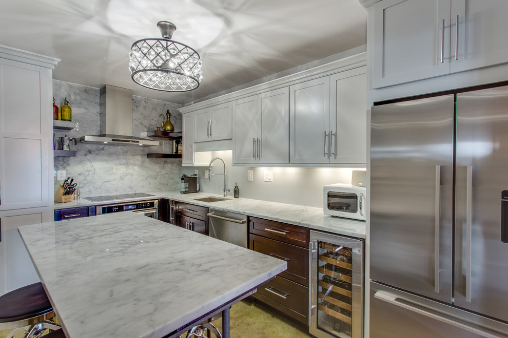 Example of a mid-sized transitional l-shaped enclosed kitchen design in DC Metro with an undermount sink, shaker cabinets, marble countertops, stainless steel appliances and an island