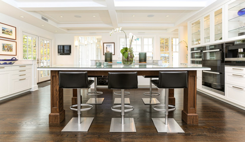 Inspiration for an expansive modern kitchen/diner in New York with shaker cabinets, white cabinets and an island.