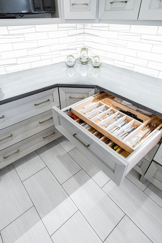 Inspiration for a large modern u-shaped porcelain tile and gray floor kitchen remodel in Other with a farmhouse sink, gray cabinets, marble countertops, gray backsplash, marble backsplash, stainless steel appliances, an island and multicolored countertops