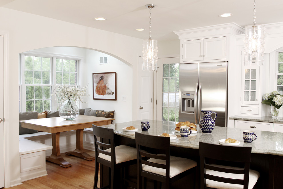 Large elegant medium tone wood floor eat-in kitchen photo in Chicago with shaker cabinets, white cabinets, stainless steel appliances, granite countertops and an island