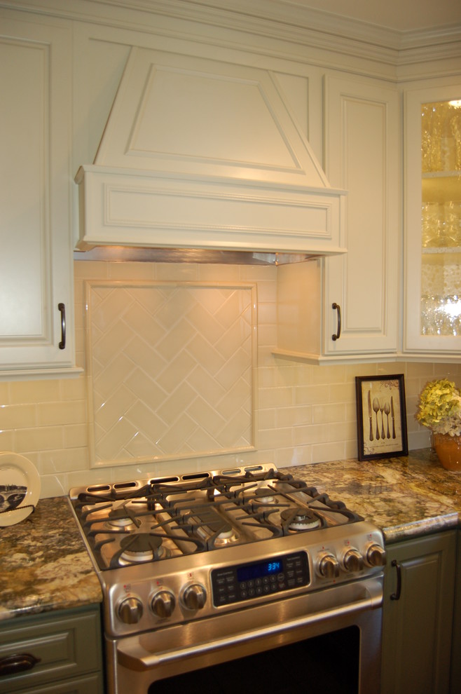 Example of a small classic u-shaped eat-in kitchen design in Orange County with raised-panel cabinets, white cabinets, granite countertops, beige backsplash, subway tile backsplash, stainless steel appliances and no island