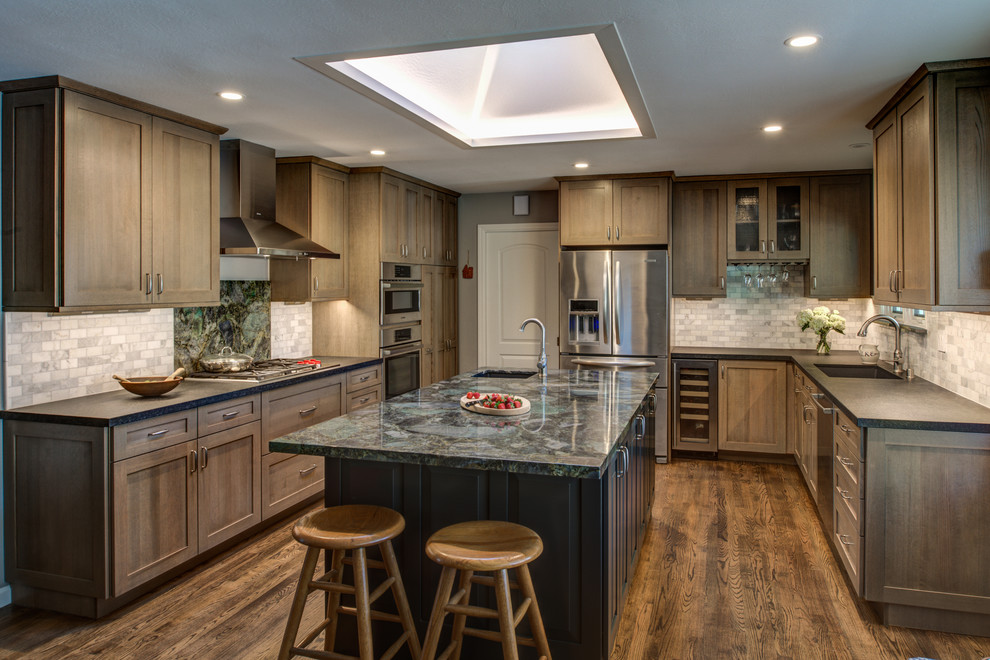 Example of a mid-sized arts and crafts u-shaped light wood floor enclosed kitchen design in San Francisco with an undermount sink, shaker cabinets, medium tone wood cabinets, granite countertops, gray backsplash, stone tile backsplash, stainless steel appliances and an island
