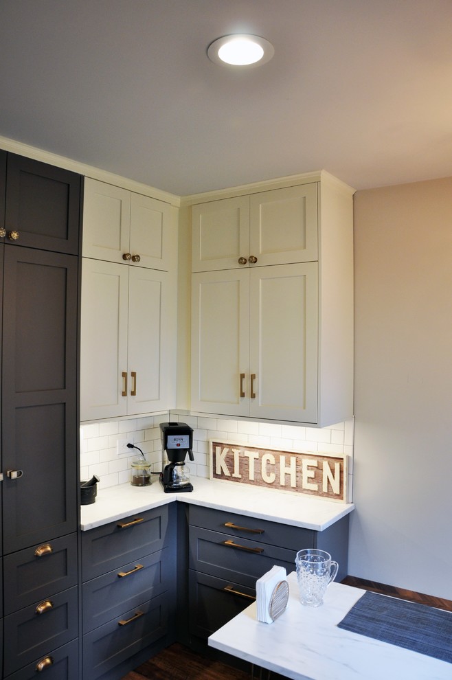 Example of a mid-sized 1950s u-shaped dark wood floor and brown floor eat-in kitchen design in Other with an undermount sink, shaker cabinets, gray cabinets, white backsplash, subway tile backsplash, stainless steel appliances, a peninsula, black countertops and soapstone countertops