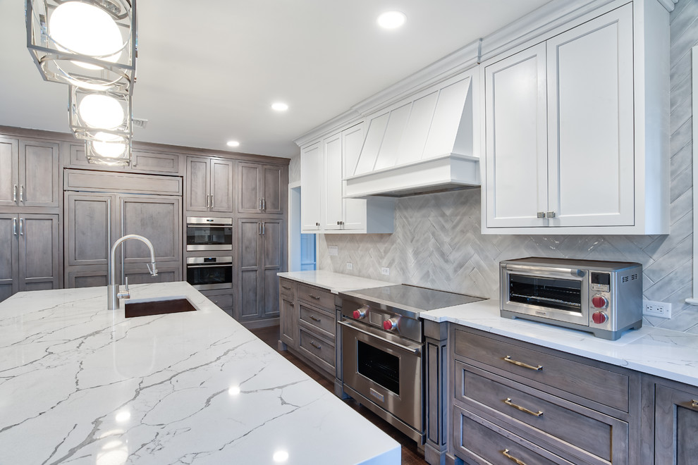 Large transitional u-shaped medium tone wood floor and brown floor eat-in kitchen photo in New York with an undermount sink, beaded inset cabinets, white backsplash, ceramic backsplash, stainless steel appliances, an island and white countertops