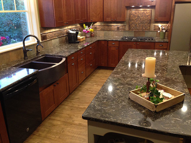 Example of a large country l-shaped kitchen design in Other with a farmhouse sink, shaker cabinets, black appliances and an island