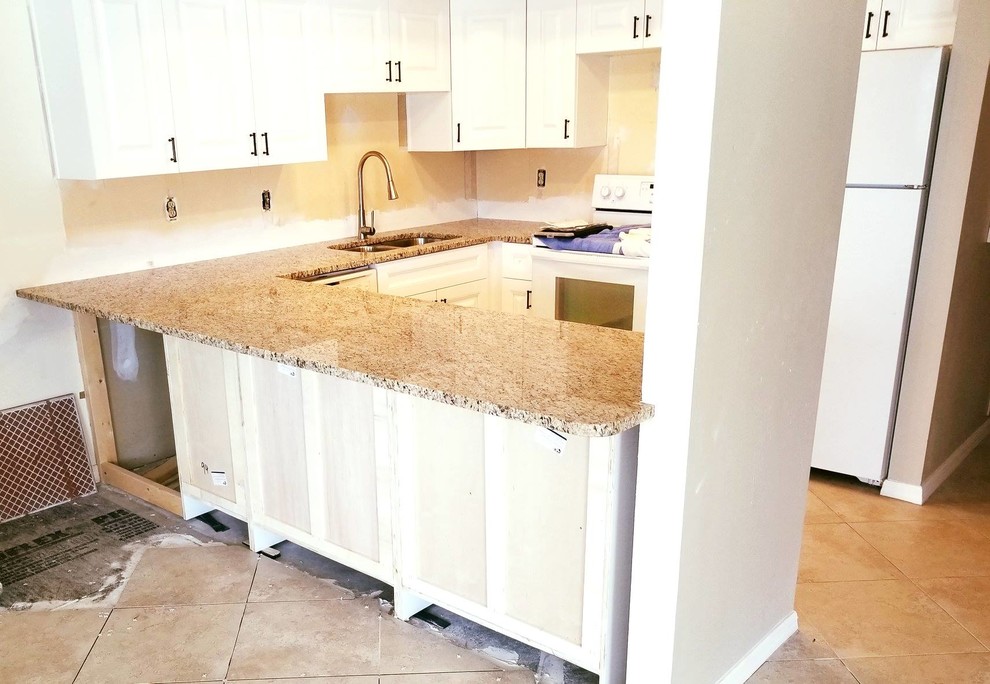 Inspiration for a mid-sized contemporary u-shaped eat-in kitchen remodel in Tampa with a double-bowl sink, granite countertops and an island