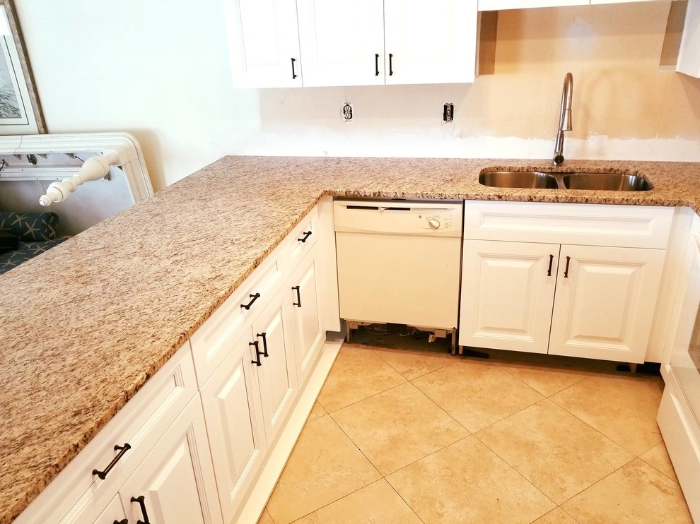 Photo of a medium sized contemporary u-shaped kitchen/diner in Tampa with a double-bowl sink, granite worktops and an island.