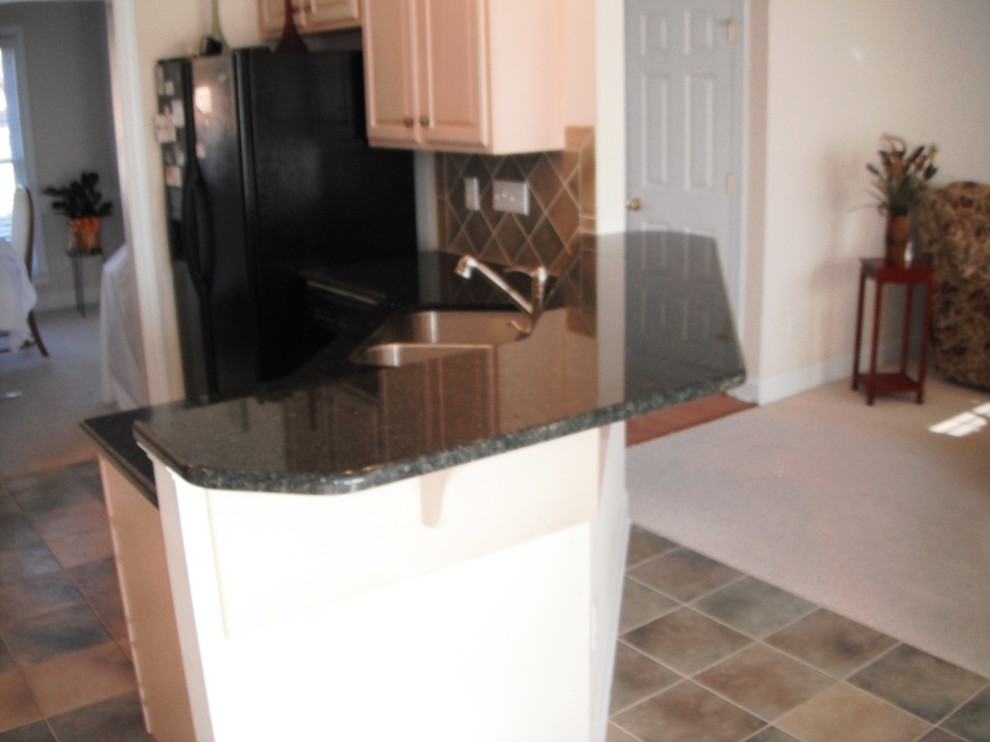 Uba Tuba Granite goes great with White Traditional Kitchen