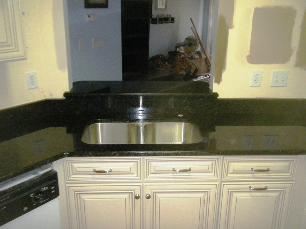 Uba Tuba Granite goes great with White Traditional Kitchen