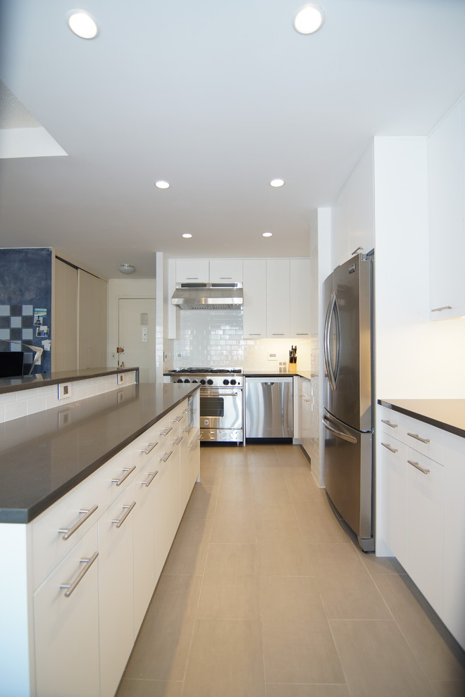 Inspiration for a mid-sized contemporary l-shaped ceramic tile open concept kitchen remodel in New York with an undermount sink, flat-panel cabinets, white cabinets, quartz countertops, white backsplash, ceramic backsplash, stainless steel appliances and an island