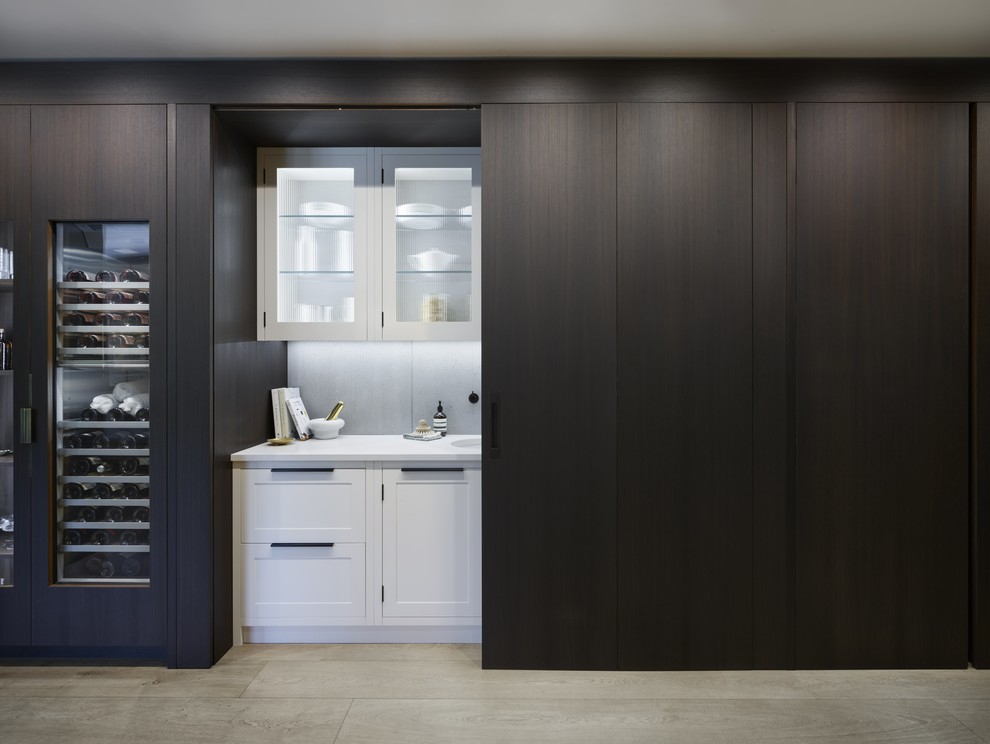 Inspiration for a small contemporary single-wall enclosed kitchen in Kent with a built-in sink, flat-panel cabinets, dark wood cabinets, quartz worktops, grey splashback, integrated appliances, light hardwood flooring, no island, beige floors and grey worktops.