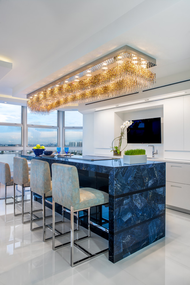 Inspiration for a mid-sized contemporary porcelain tile eat-in kitchen remodel in Miami with a single-bowl sink, flat-panel cabinets, white cabinets, quartz countertops, white backsplash, white appliances and an island