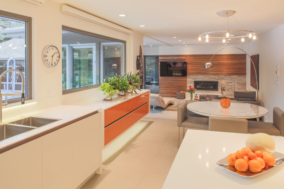 Example of a large minimalist l-shaped ceramic tile open concept kitchen design in Calgary with a double-bowl sink, flat-panel cabinets, white cabinets, solid surface countertops, white backsplash, stone slab backsplash, paneled appliances and an island