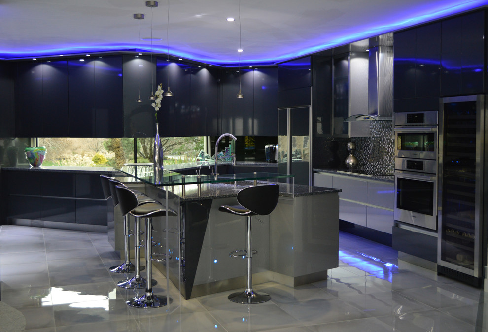 This is an example of a large modern u-shaped kitchen/diner in Other with a submerged sink, flat-panel cabinets, grey cabinets, engineered stone countertops, metallic splashback, glass sheet splashback, stainless steel appliances, porcelain flooring and an island.