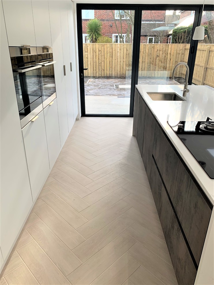 Photo of a medium sized contemporary single-wall kitchen/diner in Other with a submerged sink, flat-panel cabinets, medium wood cabinets, engineered stone countertops, black appliances, porcelain flooring, an island and white worktops.
