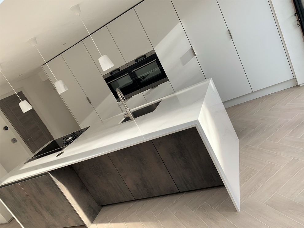 Photo of a medium sized contemporary single-wall kitchen/diner in Other with a submerged sink, flat-panel cabinets, medium wood cabinets, engineered stone countertops, black appliances, porcelain flooring, an island and white worktops.