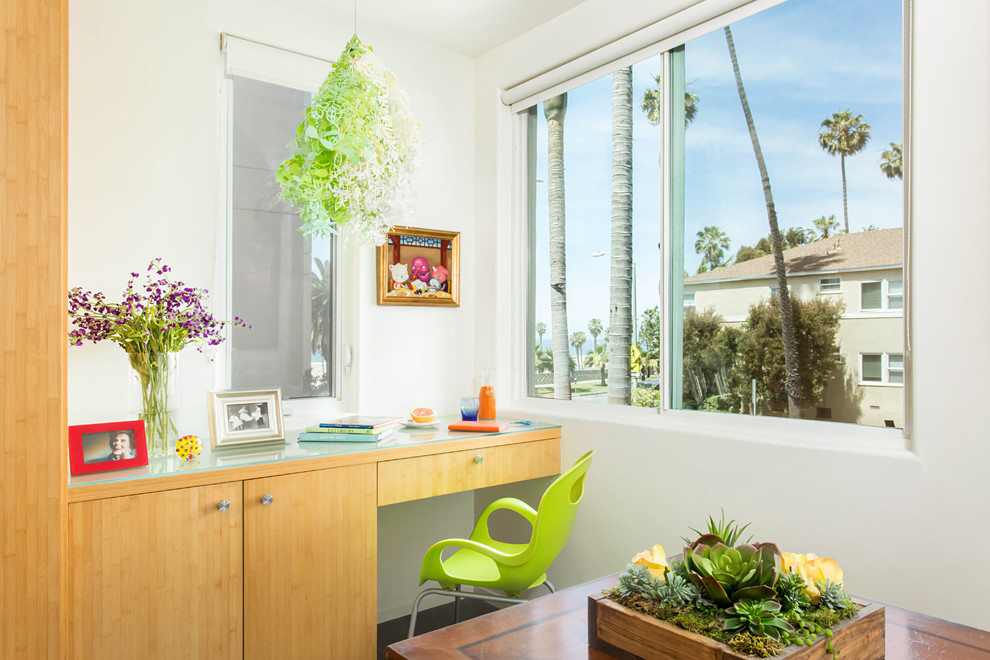 Mid-sized beach style u-shaped porcelain tile and gray floor eat-in kitchen photo in Los Angeles with a double-bowl sink, flat-panel cabinets, light wood cabinets, granite countertops, blue backsplash, glass sheet backsplash, stainless steel appliances and an island