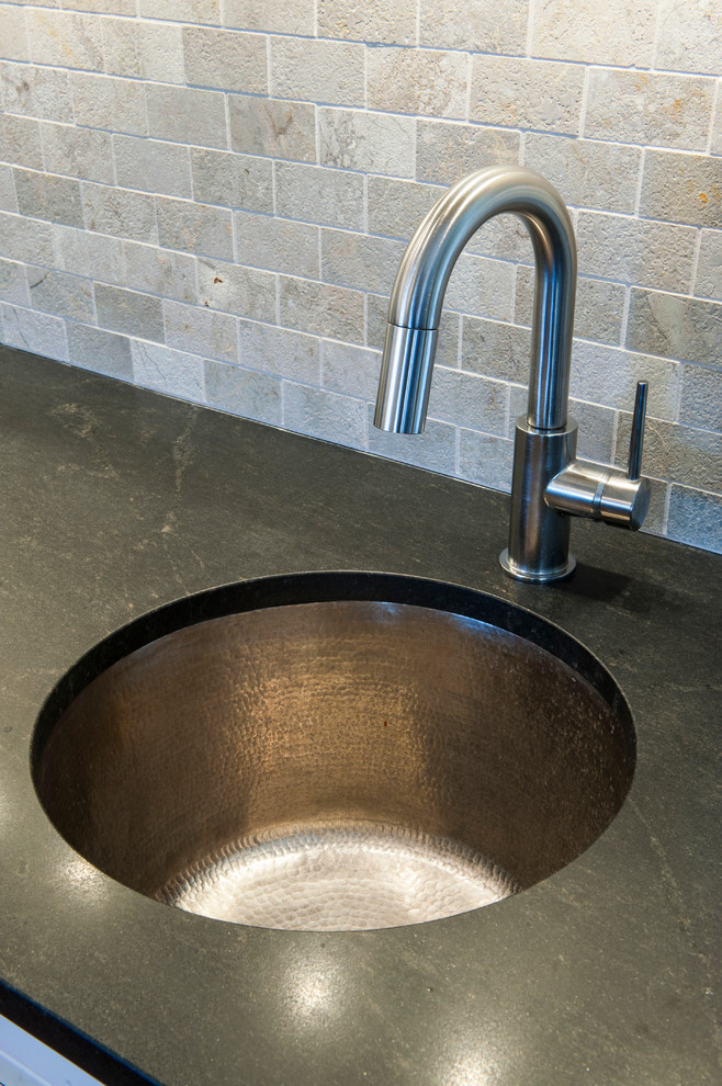 Undermount, Hammered Sink, Stone Tile Backsplash, and Honed Granite