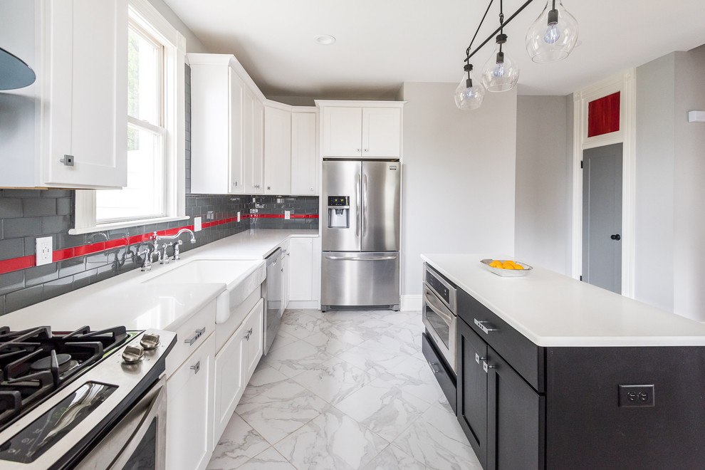 Inspiration for a mid-sized modern single-wall porcelain tile open concept kitchen remodel in Wilmington with a farmhouse sink, shaker cabinets, white cabinets, solid surface countertops, gray backsplash, ceramic backsplash, stainless steel appliances and an island