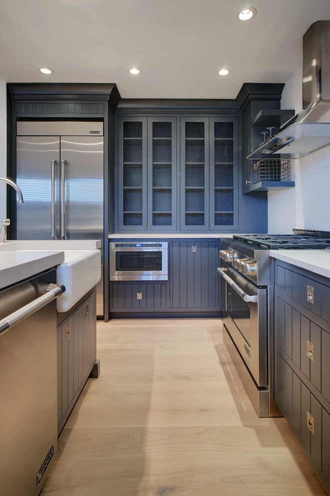Beach style kitchen photo in Boston with black cabinets, quartz countertops and porcelain backsplash