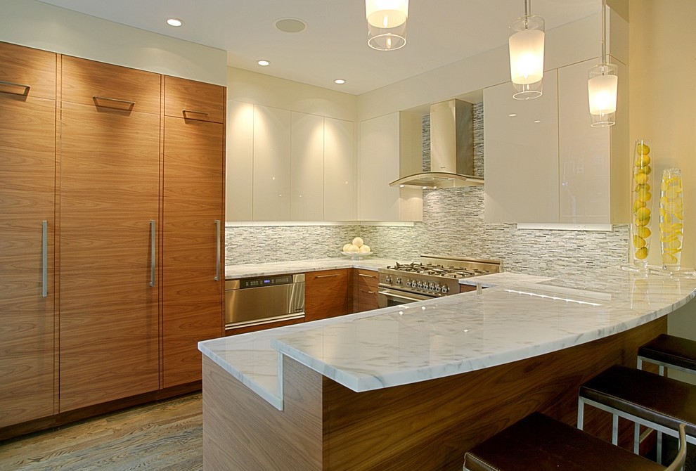 Moderne Küche mit Küchengeräten aus Edelstahl, flächenbündigen Schrankfronten, weißen Schränken und Marmor-Arbeitsplatte in Boston