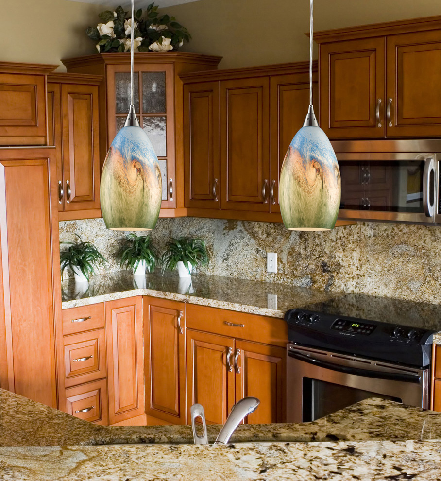 Inspiration for a large timeless l-shaped enclosed kitchen remodel in New York with shaker cabinets, medium tone wood cabinets, granite countertops, multicolored backsplash, stone tile backsplash, stainless steel appliances and an island