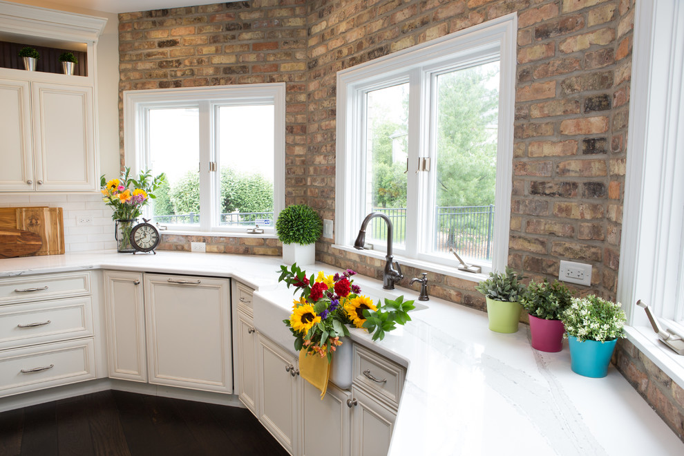 Inspiration for a large transitional u-shaped dark wood floor and brown floor eat-in kitchen remodel in Chicago with a farmhouse sink, shaker cabinets, white cabinets, quartz countertops, multicolored backsplash, subway tile backsplash, paneled appliances, an island and multicolored countertops