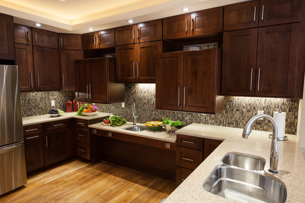Mid-sized transitional u-shaped light wood floor enclosed kitchen photo in DC Metro with a double-bowl sink, shaker cabinets, medium tone wood cabinets, quartz countertops, brown backsplash, ceramic backsplash, stainless steel appliances and an island