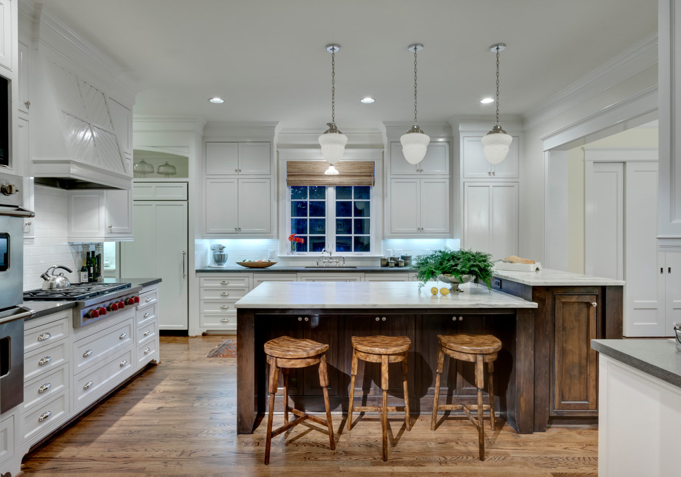 Photo of a traditional kitchen in Dallas with shaker cabinets, white cabinets and integrated appliances.